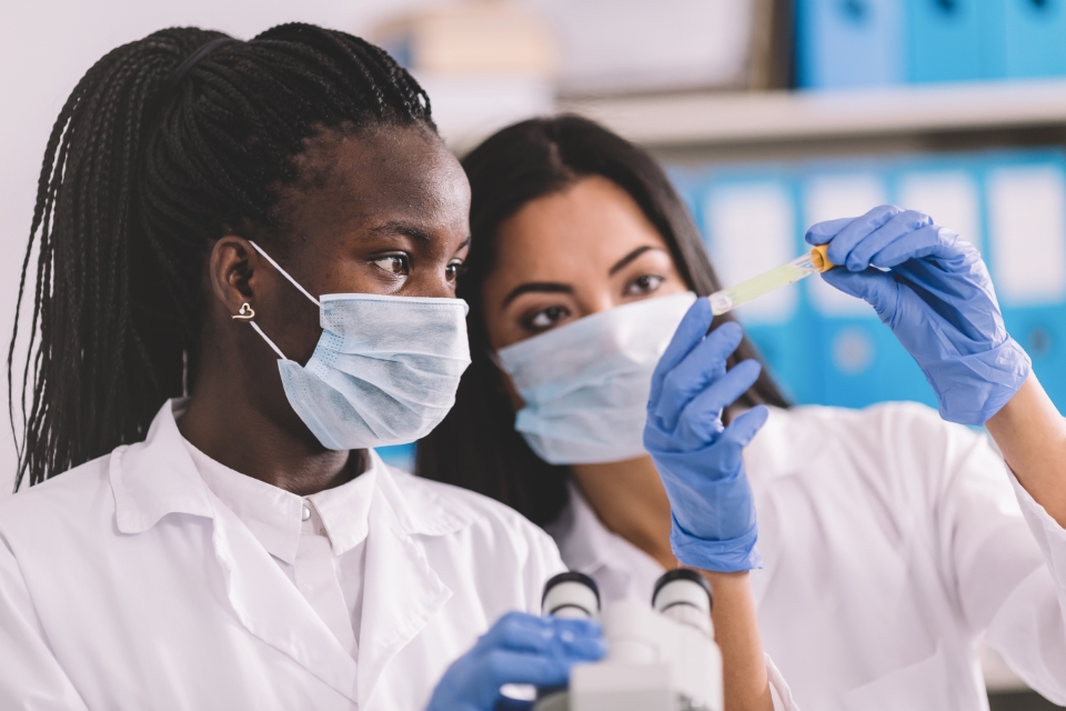 lab workers looking a test tube