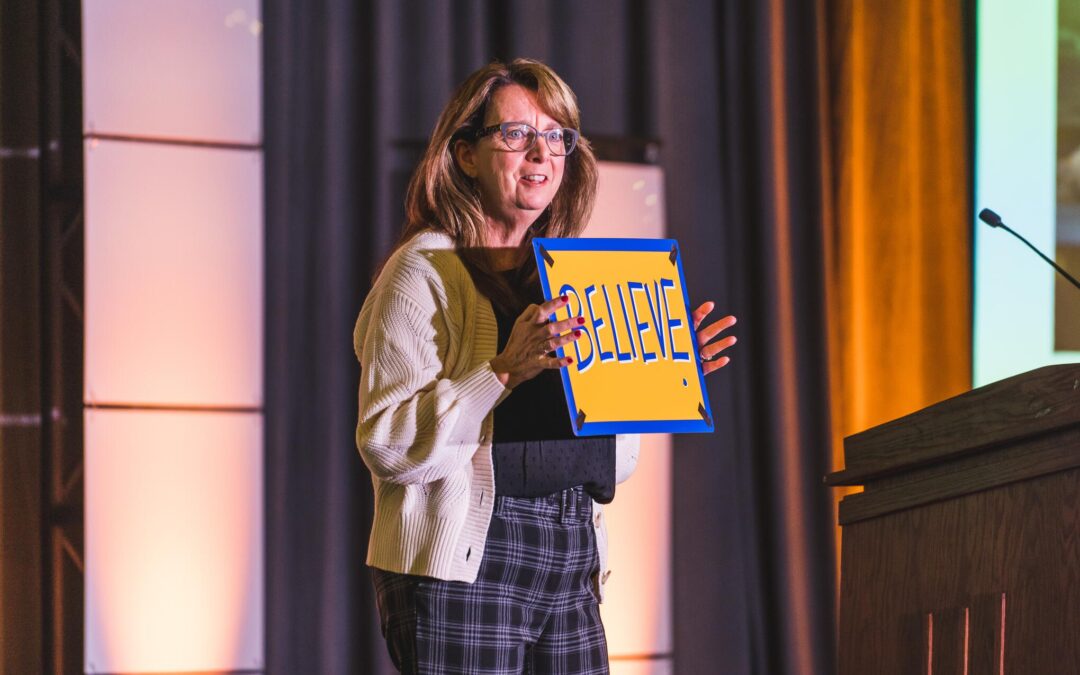Robin Tuohy with a believe sign